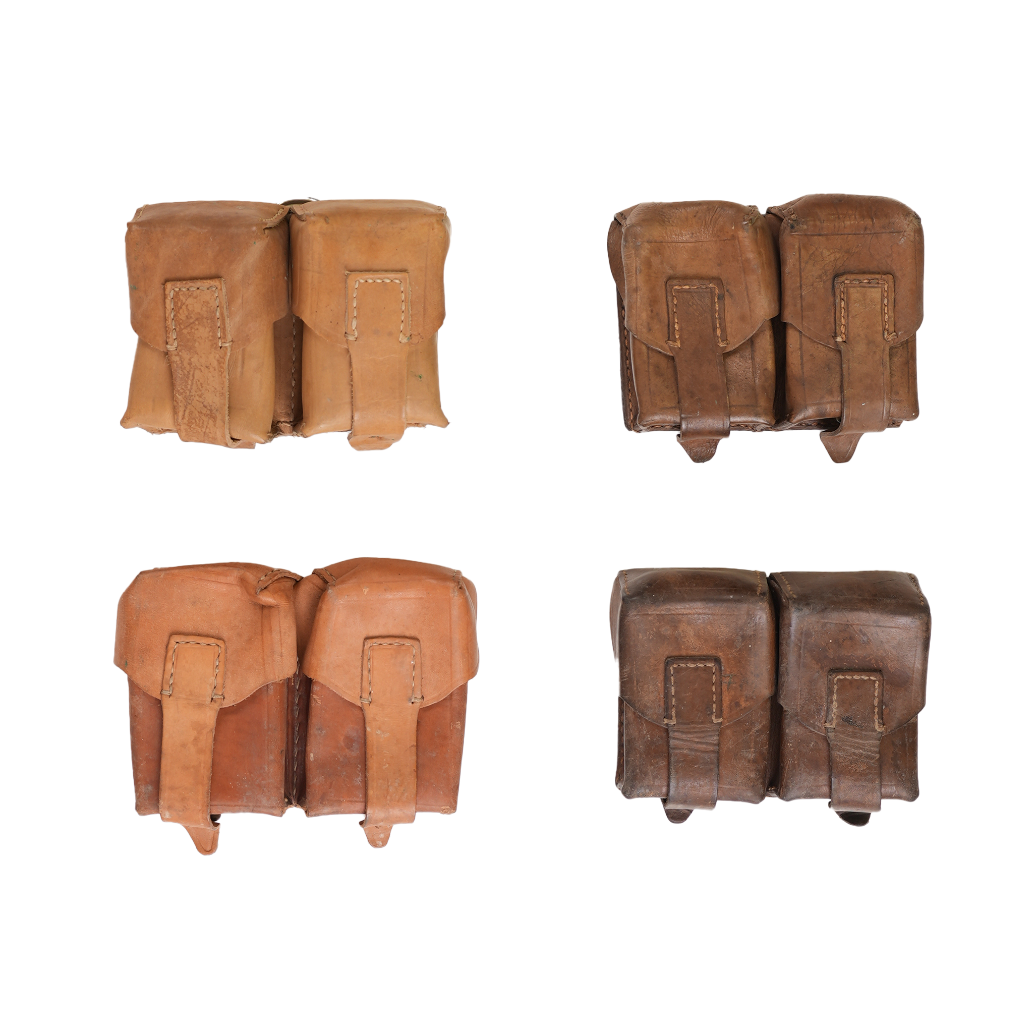 Four Serbian leather double mauser/SKS stripper clip pouches in different shades of brown and tan, displayed against a white background.