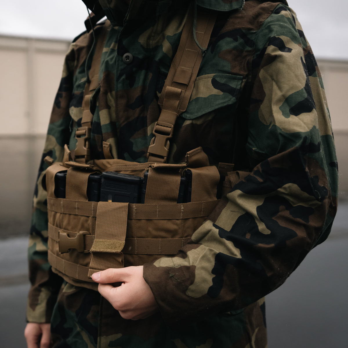 Close up of man adjusting USMC TAP Chest Rig