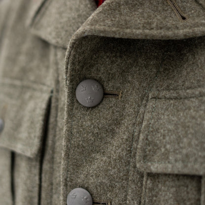 Close up of engraved metal buttons on Swedish wool field jacket