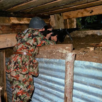Soldier aiming weapon while wearing TAZ 57 Alpenflage M61/70 Field Jacket